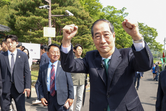 한덕수 무소속 대선 예비후보가 8일 경북 구미시 박정희 전 대통령 생가를 방문, 지지자들에게 두 손을 들어 인사하고 있다. [연합뉴스]